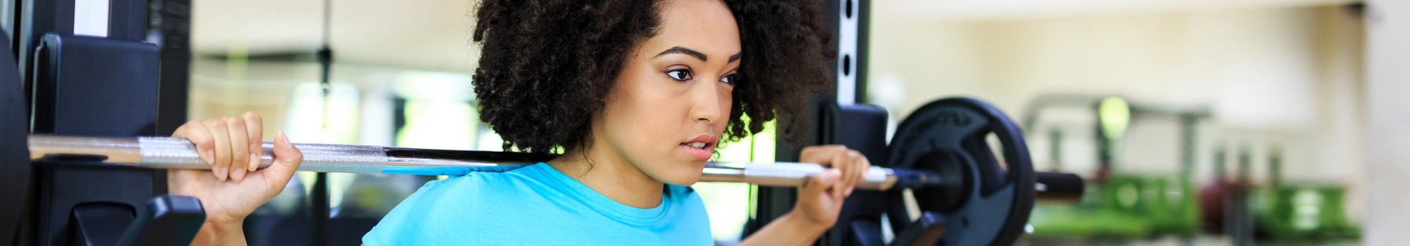 Girl using weight bar